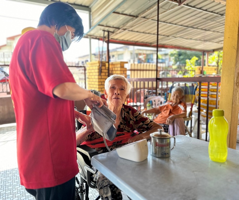 Blood pressure check for elderly resident at Amitabha Foundation